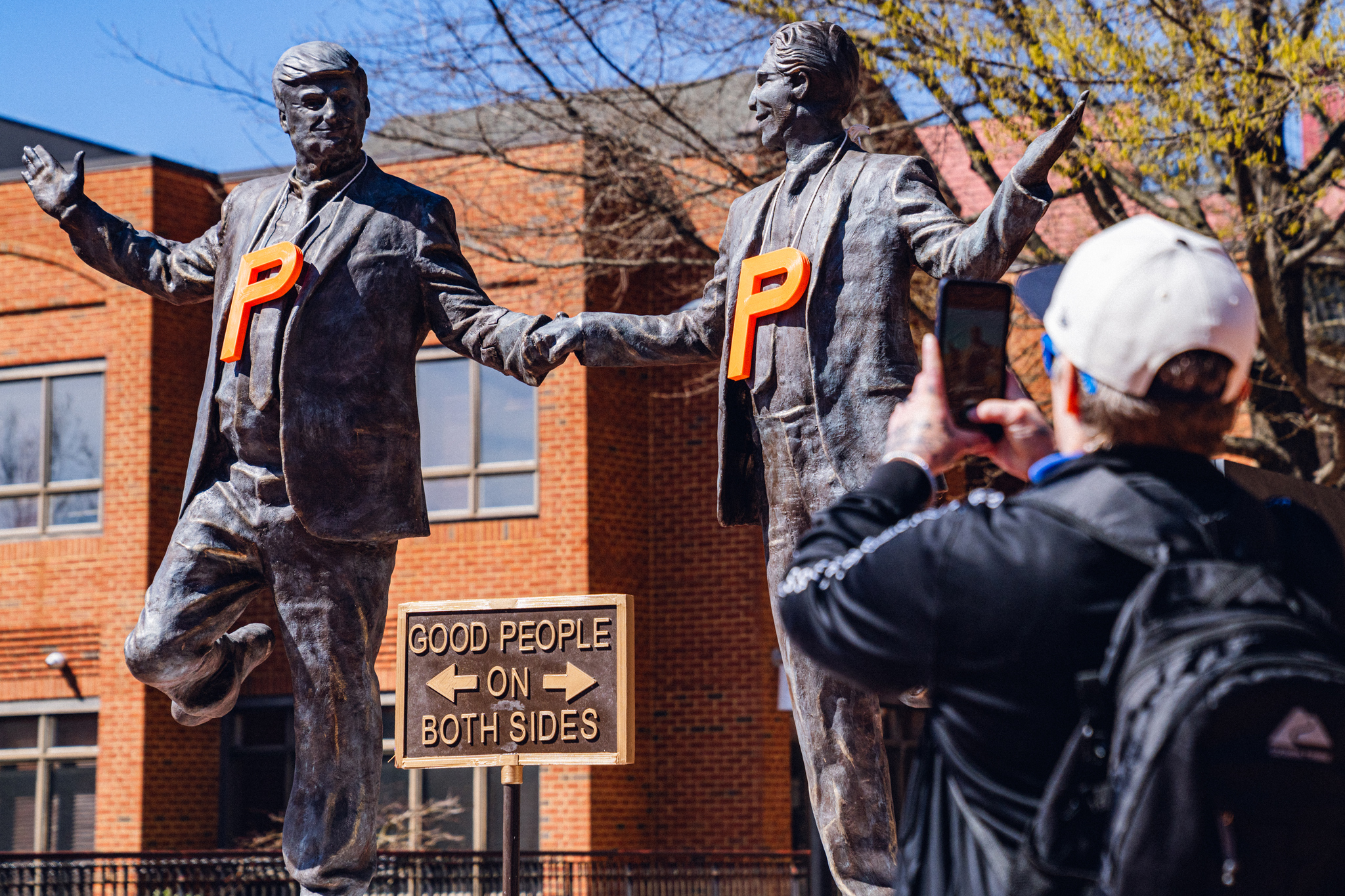 Sculpture of the president and Jeffrey Epstein appears briefly on the Downtown Mall